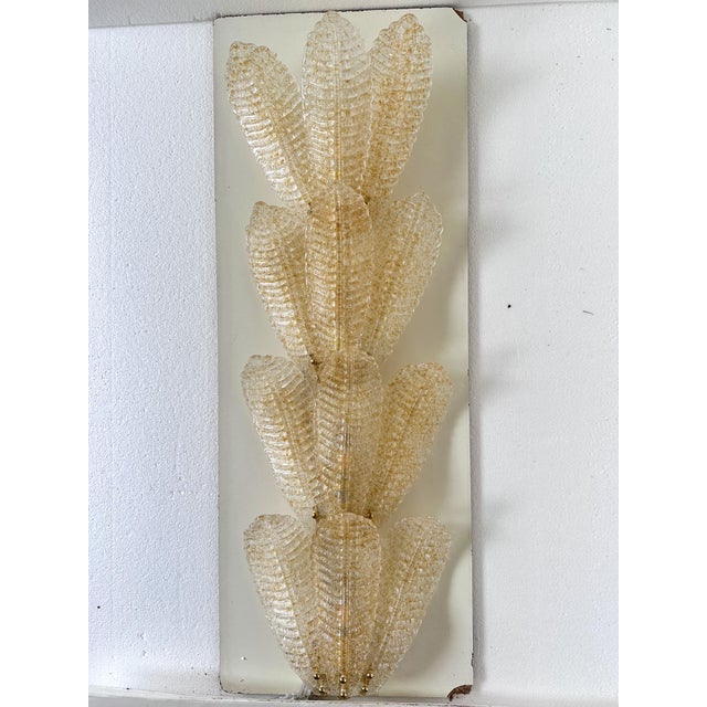 Contemporary luxury wall sconces in gold metal frame with Leaves in Murano glass and amber graniglia. A piece of hight...