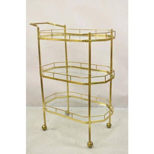 Vintage Mid Century Italian Modern Brass and Glass 3 Tier Rolling Bar Cart Serving Table. Item features a very rare 3 tier...