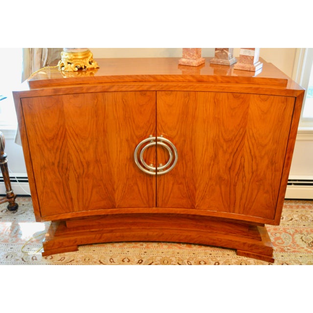 Exquisite curvature and rich figured wood grains bring architectural interest to this extraordinary door cabinet. Raised...