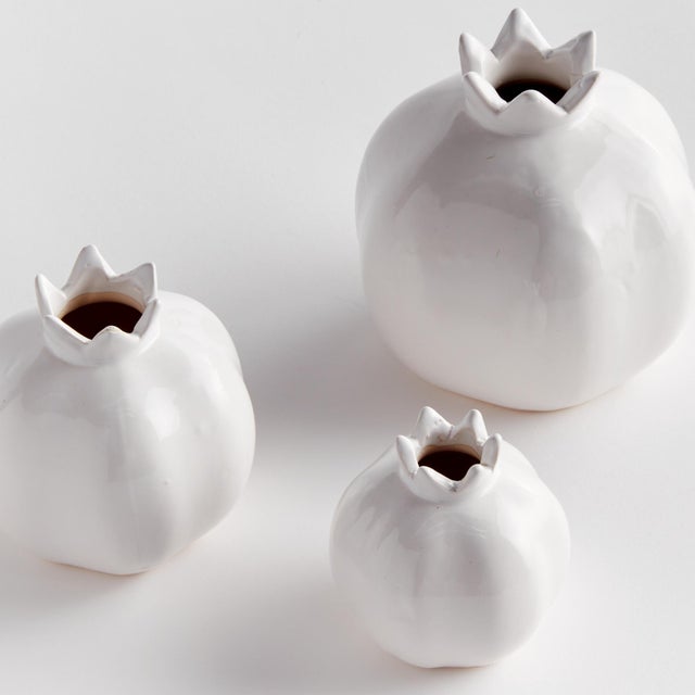 Simple and sweet, this set of three bud vases are pomegranateinspired. They make the perfect little accent for side table,...