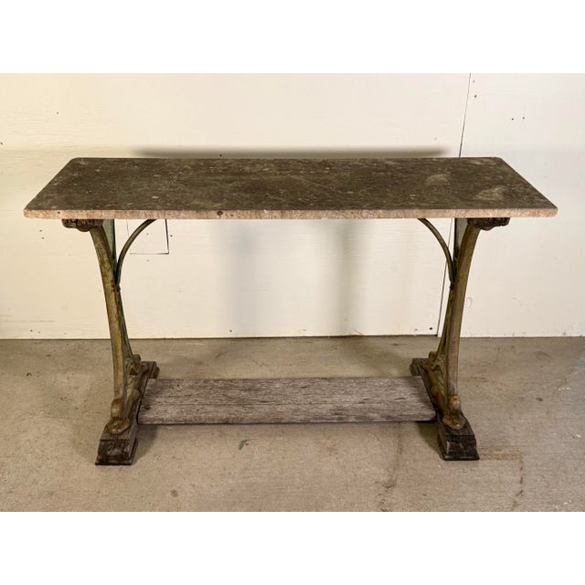 This antique French iron and marble garden console table, dating to the early 1900s and sourced in France, beautifully...