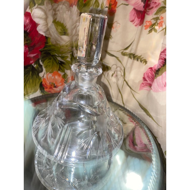 A vintage cut crystal perfume decanter with a faceted stopper. Cut glass, particularly crystal, has a long history dating...