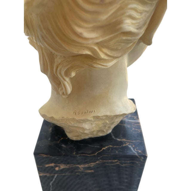 A refined classical female bust produced by A. Santini in the mid-20th century, Italy, exemplifying the Neoclassical...