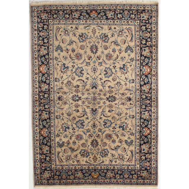 Antique hand-knotted Persian Mashad wool rug with a warm beige field featuring an allover floral pattern of scrolling...