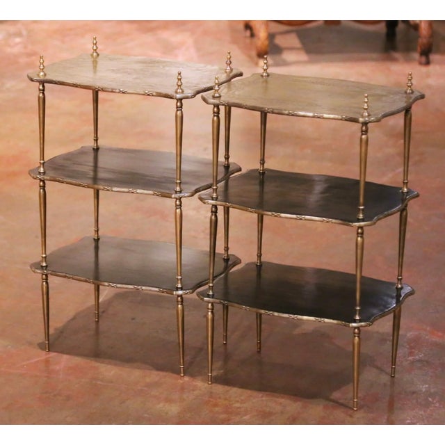 Crafted in France circa 1880, this elegant pair of Napoleon III three-tier side tables combines refined decorative detail...