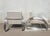 Pair of large chrome armchairs with rounded tubing, in the Art Deco style; based on the Hudson model by designer Ralph...