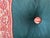 A pillow made from an iconic Fortuny printed fabric border motif, button tuft detail.