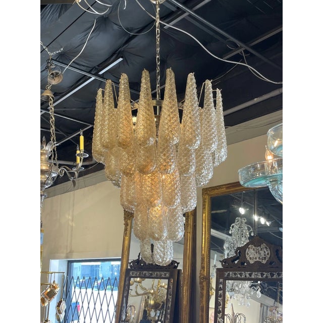 Beautiful vintage Italian gold Murano glass tear drop waterfall chandelier. Featuring gorgeous layers textured glass. Such...