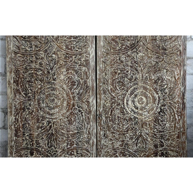 Elevate your interiors with this vintage carved wood lotus medallion barn door, a striking artisan piece rich in texture...