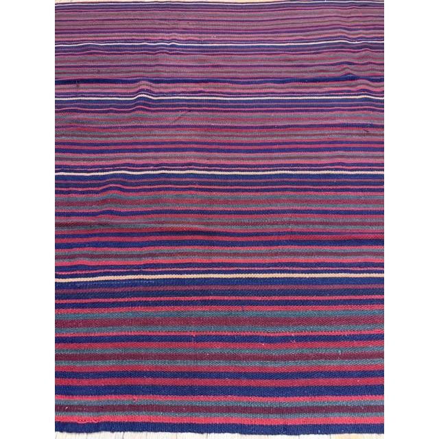"This is a vibrant and highly authentic vintage mid-century Turkish Kilim, dating back to circa 1950. Measuring a...