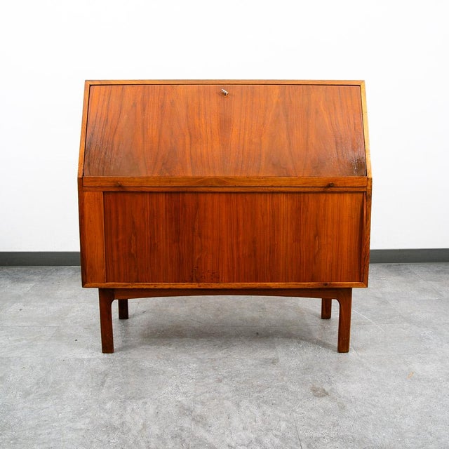 Fantastic Teak secretary desk with tambour door storage and drop leaf desk surface. comes with 4 dovetailed drawers and...