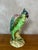 Charming ceramic vase depicting a parrot perched on a branch, dating from the 1920s. This decorative piece captivates with...