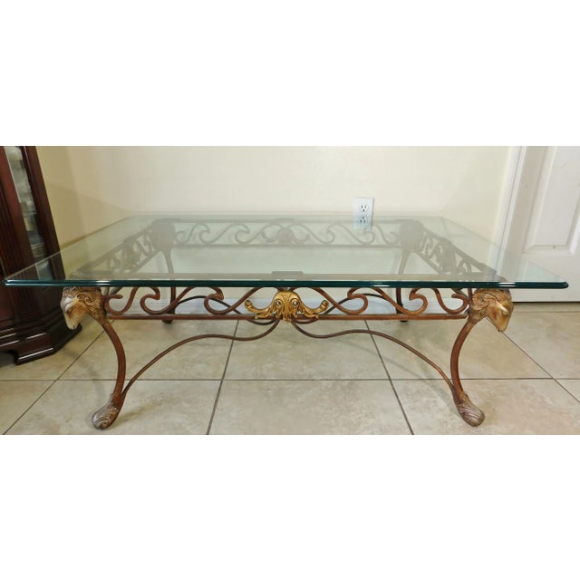 Beautiful vintage neoclassical wrought iron sculptural ram's head coffee table with half inch thick glass top. Beautiful...