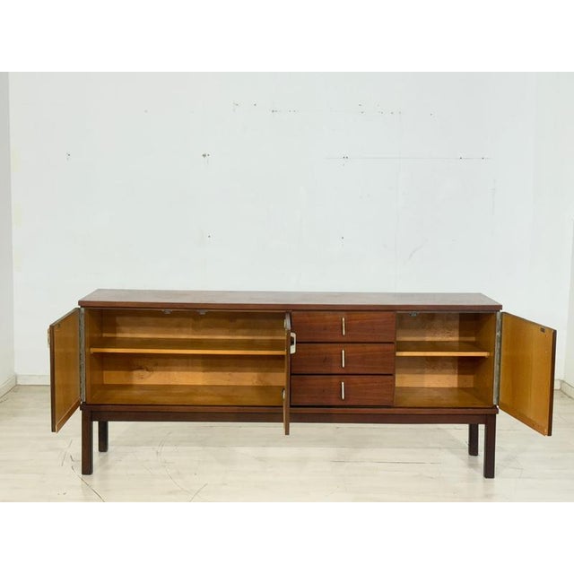 For sale is a high-quality vintage teak sideboard from the 1970s. This piece of furniture impresses with its clean, mid-...