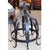 A half dome shaped pot rack, a Continental shape known as a "Dutch crown," featuring fleur-de-lys and scrolling decorative...