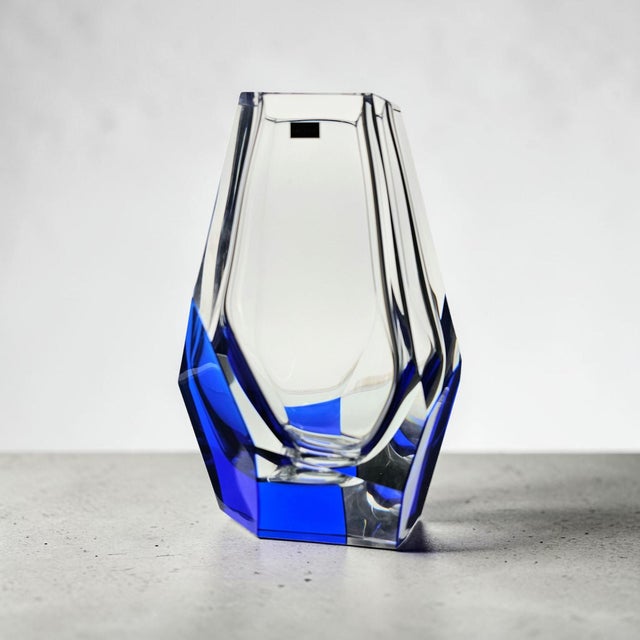 This Japanese crystal vase reveals its drama in the meeting of cobalt blue and clear glass, cut into sharp faceted planes...