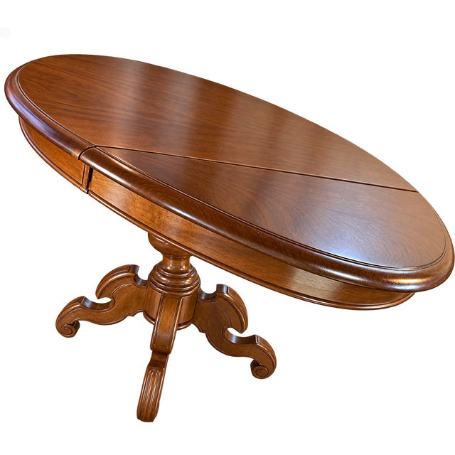 Elegant French walnut drop-leaf table dating to the mid-to-late 19th century. The table features a beautifully figured...