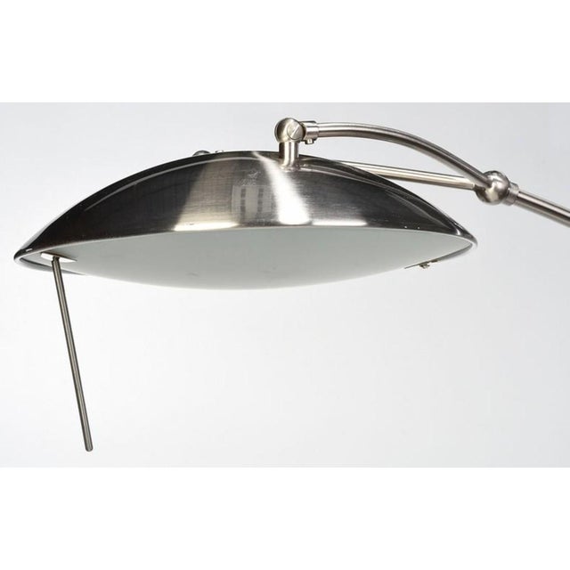 modern, arched curved stand with disk shaped shade, black marble base, approximately 78 in,, Provenance: Private...