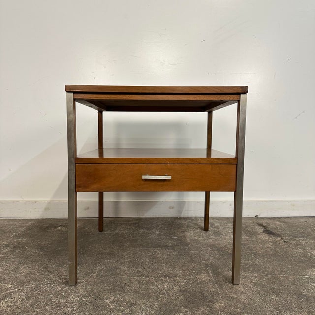 Mid Century Modern Paul McCobb for Calvin End Table. This side table features walnut wood with aluminum details. There is...