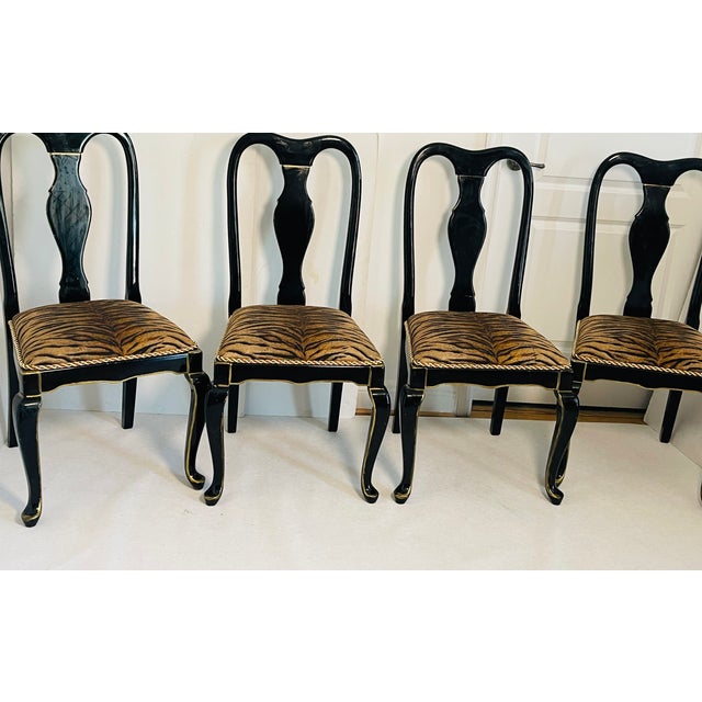 Set of 4 gorgeous dining chairs in black lacquer and whith animalistic tapestry. Queen Ann style chairs.