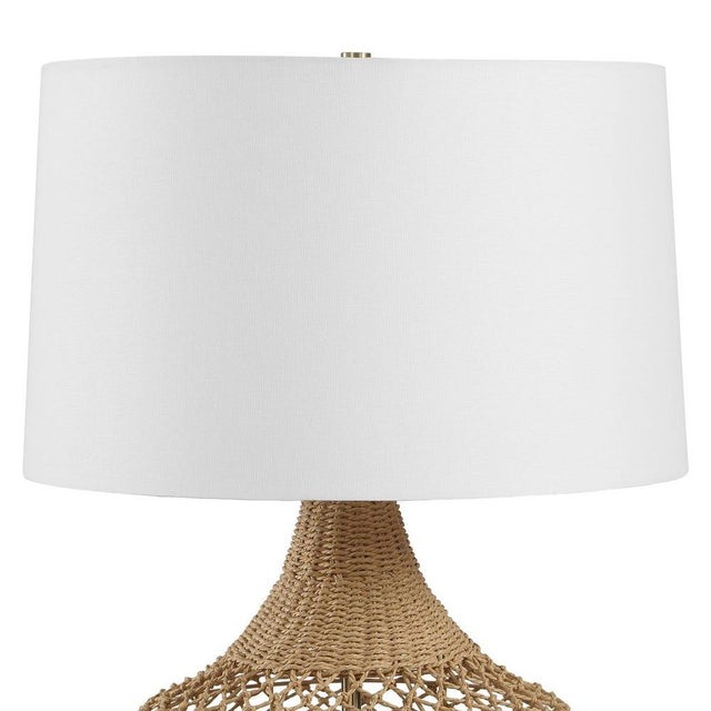 Bring natural texture and relaxed sophistication to your space with this beautifully crafted table lamp, featuring an...