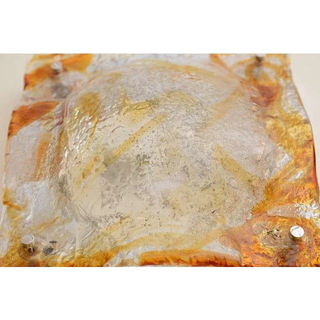 These amazing and beautiful set of 6 vintage sconces of Murano glass by Mazzega have fused amber, orange and clear glass...