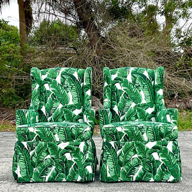 A fabulous pair of vintage Coastal wingback chairs. A chic modified scale with a clean and modern look. Upholstered in a...