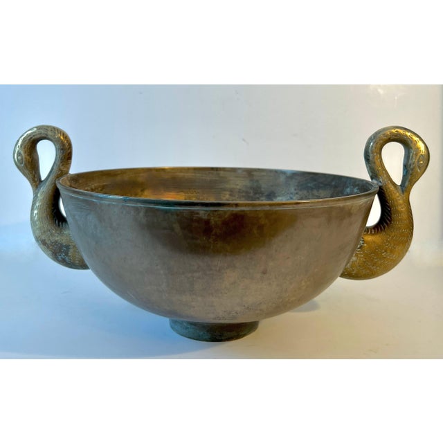 A Very heavy French Art Deco bronze bowl resting on a small cylindrical foot with Swan Handles flanking either side. The...