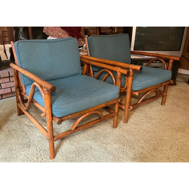 This charming pair of vintage mid-century modern (likely 1970s-1980s) bamboo lounge chairs features sculptural, organic...