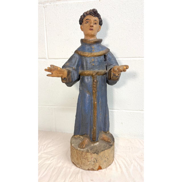 Immerse yourself in the spiritual artistry of the 17th century with this sizable antique St. Francis Santos sculpture....