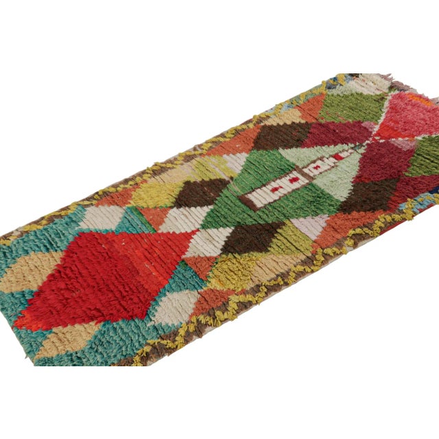 Hand-knotted in wool circa 1940-1950, this 3x6 vintage Moroccan runner is believed to hail from the Azilal tribe. On the...