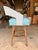 Contemporary counter stool featuring a clean, minimalist silhouette with a natural wood frame and a comfortable leather...
