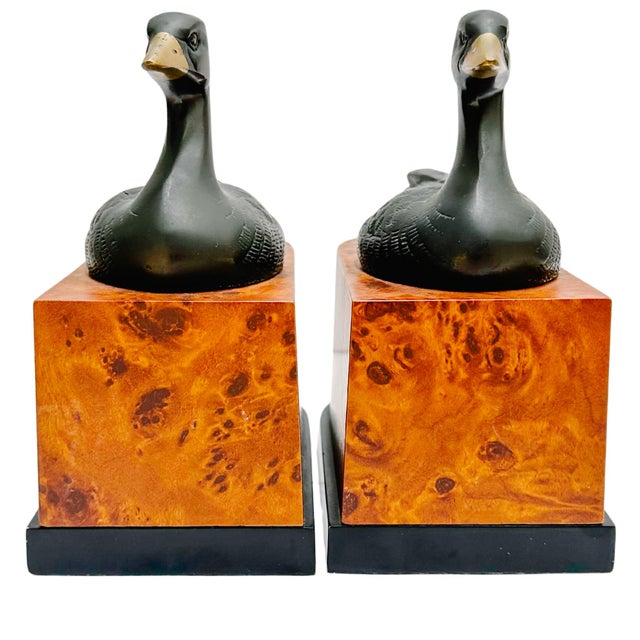 Pair of Art Deco ebonized brass duck bookends on burlwood bases. They are impressive in size and design, and will...