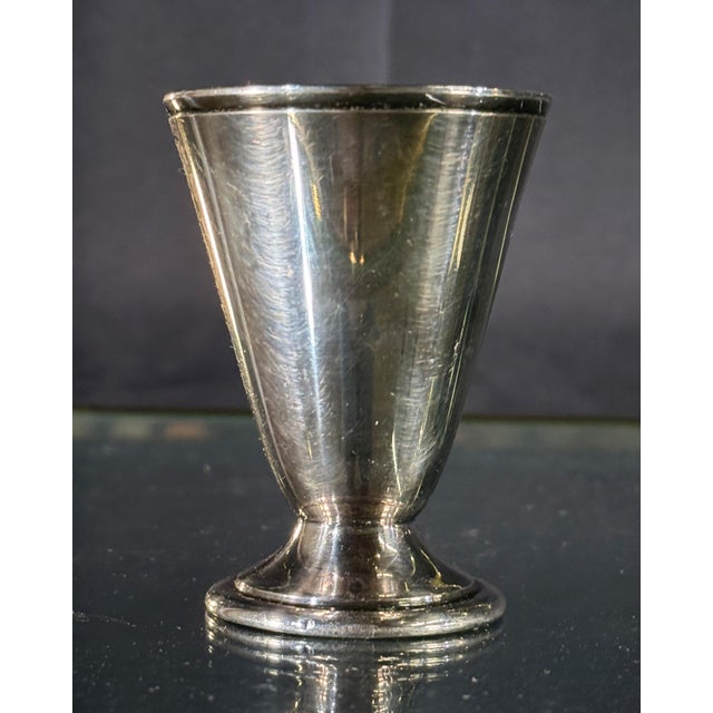 This small footed jigger by Reed & Barton, c.1920's/30's, has a clean flared conical form on a stepped circular base, with...