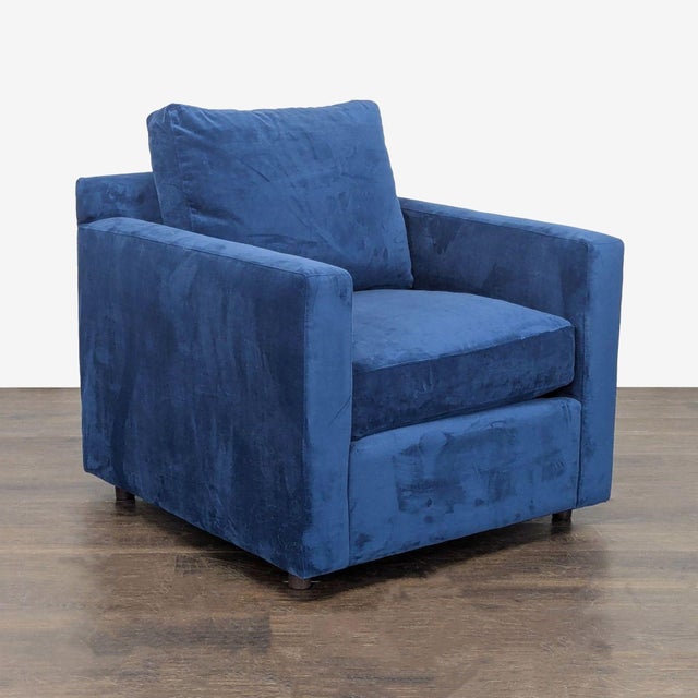 This Crate & Barrel lounge chair features a deep blue velvet fabric and a clean, modern design. The plush seat and back...