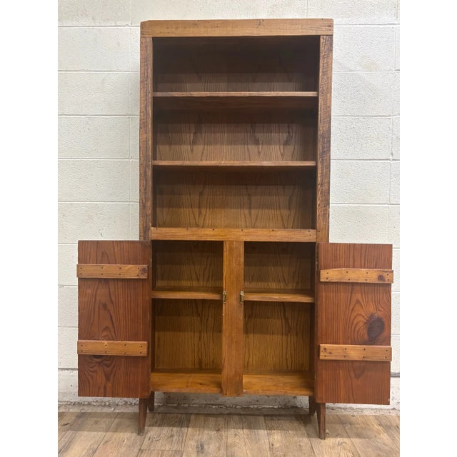 This is a stunning vintage, possibly antique, primitive style pine step back cupboard. It features a spacious cabinet...