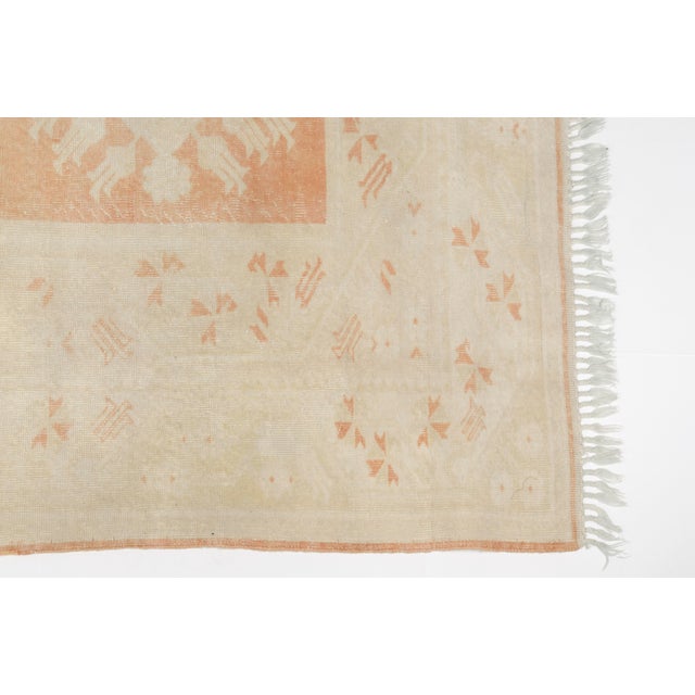 This is a vintage Turkish Oushak rug from the 1960s. The piece was hand-knotted.