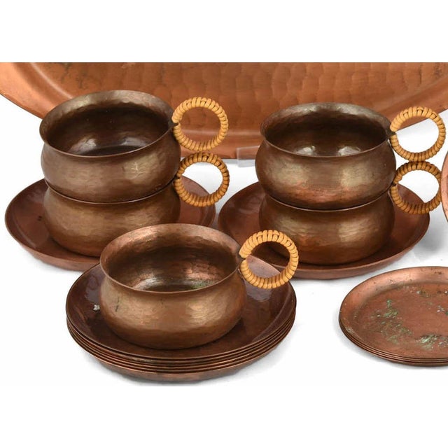 Copper tea set is an original decorative object realized in the 1960s. The lot includes several handmade pieces: a teapot,...