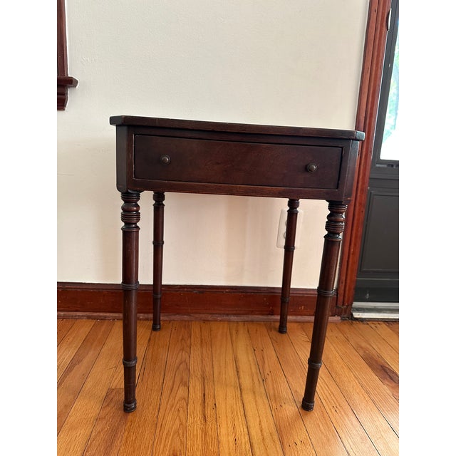 Bring a touch of historic Boston elegance into your home with this exceptional Federal-style mahogany side table from the...