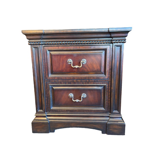Pair of Maitland-Smith nightstands constructed with book-matched mahogany veneers, rope-twist trim under the top edge, and...
