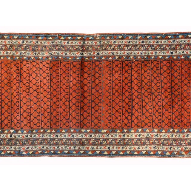 A gorgeous early 20th century Azerbaijani Karabak runner with a central field with a geometric trellis pattern woven in...