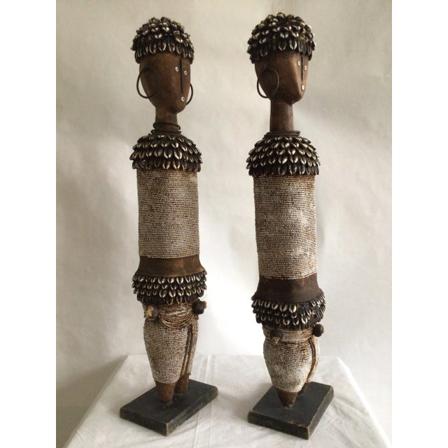1990s Pair of Wood And Shells Beaded Namji Dolls Made with wood, beads and cowrie shells Metal Earings Some cracks in the...