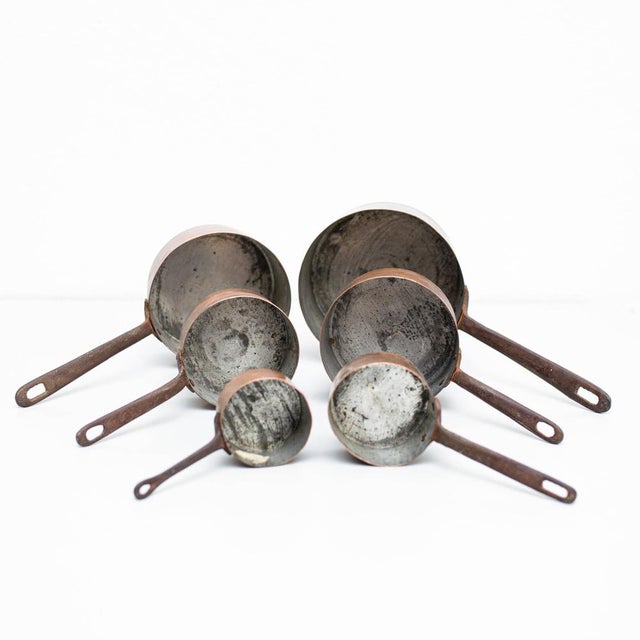 Set of Six Brass Pots – Spain, Circa 1950 : This elegant set of six brass pots, crafted by an unknown manufacturer in...