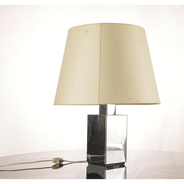 This table lamp, with its imposing base and classic lampshade, fits into the modernist aesthetic, featuring clean lines...