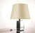This table lamp, with its imposing base and classic lampshade, fits into the modernist aesthetic, featuring clean lines...