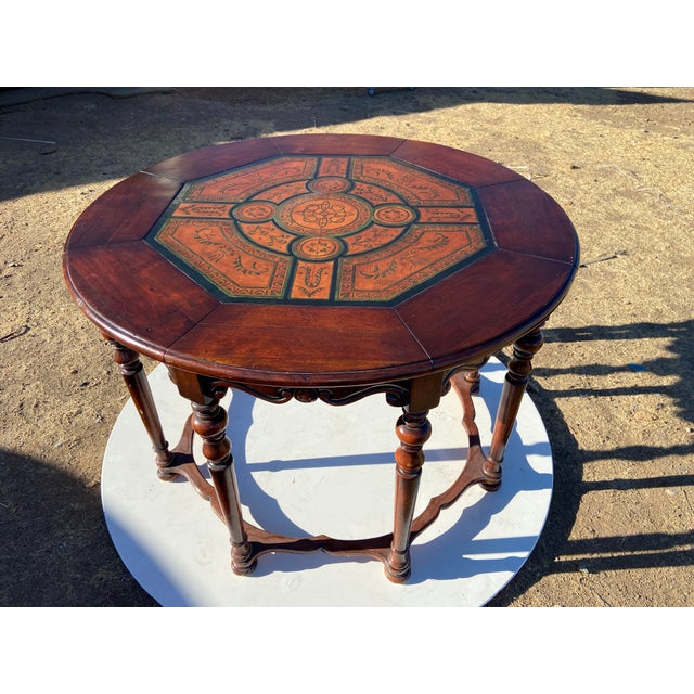 This Vintage English Eight-Legged Inlaid Table is a unique and stylish dining table with a round shape and a bohemian...