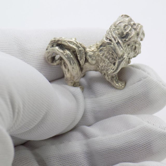 Compact vintage sculpture with an impressive presence, depicting a pekingese dog, handcrafted in italy between the 1950s...