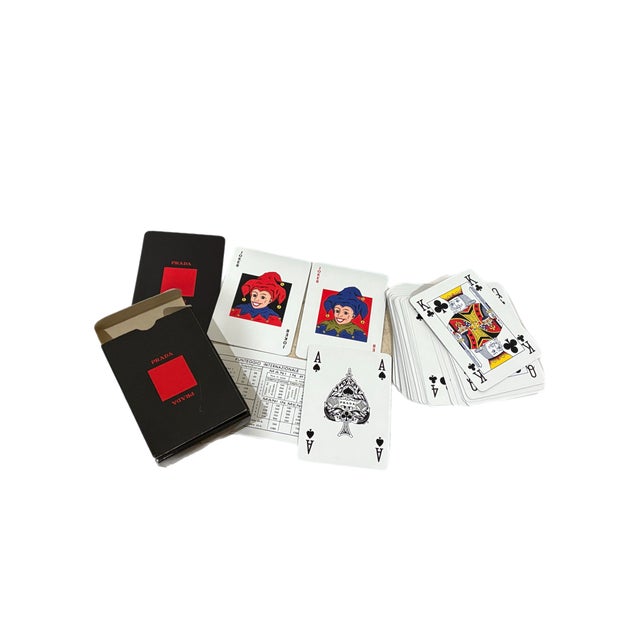 Prada two-deck playing card set produced by Dal Negro in Treviso, Italy, with red and black Prada-branded decks in a rigid...