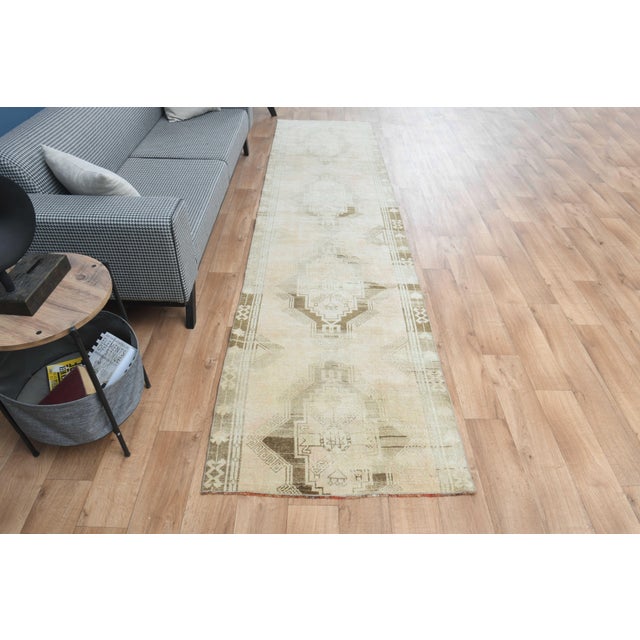 Vintage Hand-Knotted runner rug is a semi-antique vintage area rug. The '70s Eastern region of Anatolia's unique rug is...