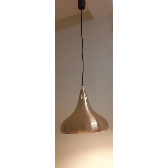 Vintage ceiling light from the 70s with a funnel-shaped lampshade in copper-coloured anodized aluminium. European Plug (up...
